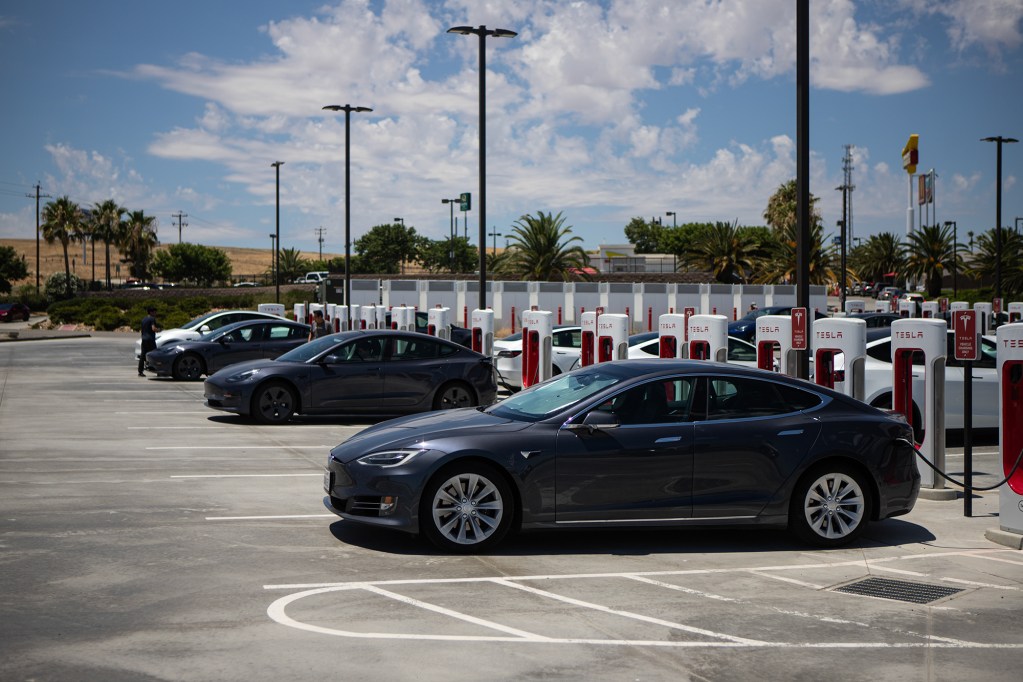Tesla vehicles charging at the Tesla Supercharger lot in Kettleman City on June 23, 2024. Photo by Larry Valenzuela, CalMatters/CatchLight Local