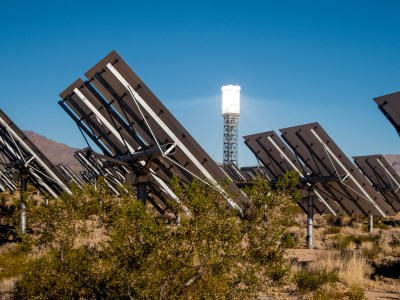 Solar panels face the sun in the Mojave desert on a clear sky day.